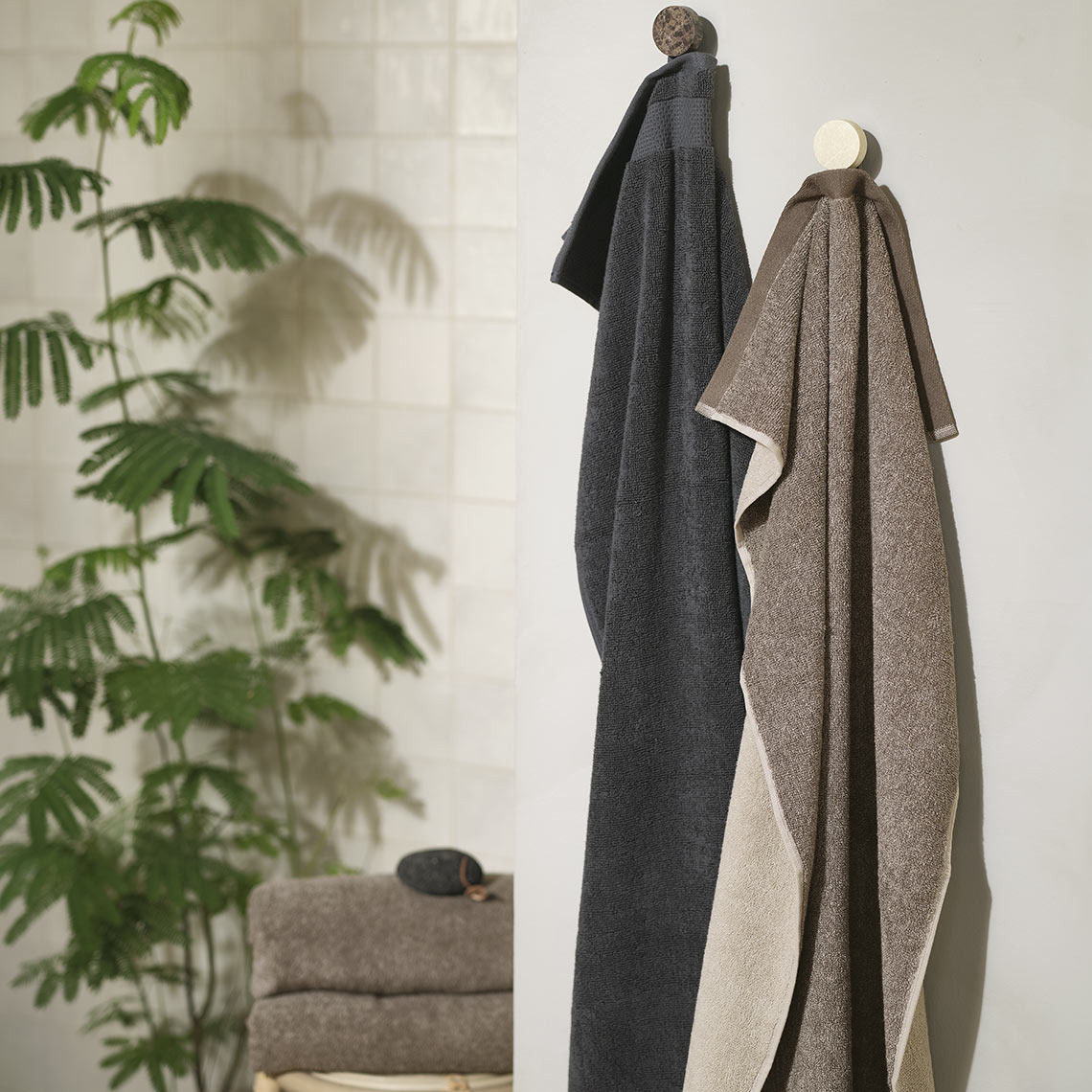 MUNKTORP towel has a reversible design with a lighter and a darker side Cotton towels in a bathroom