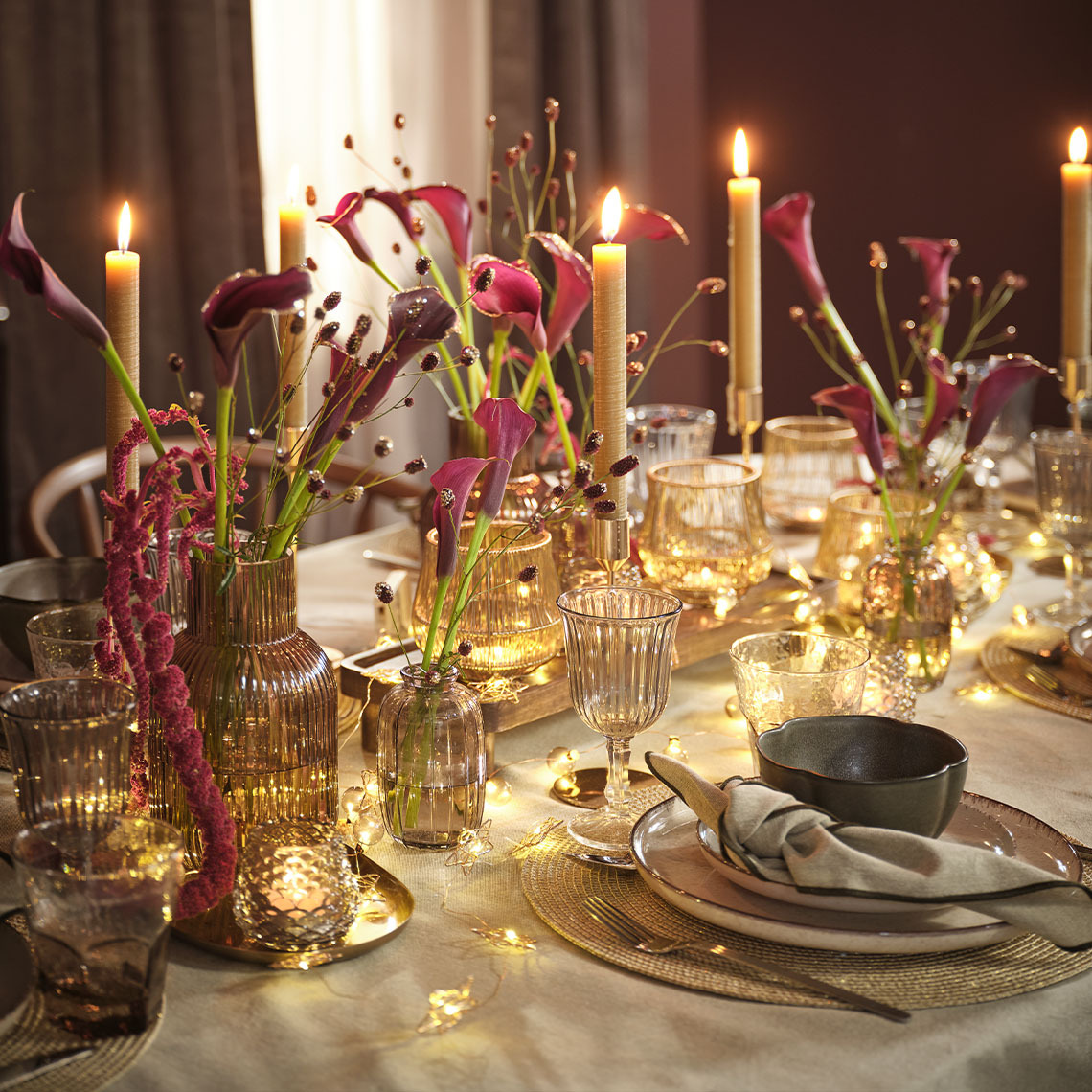 Table adorned with flowers, wine glasses, cloth napkin, placemat and bowl