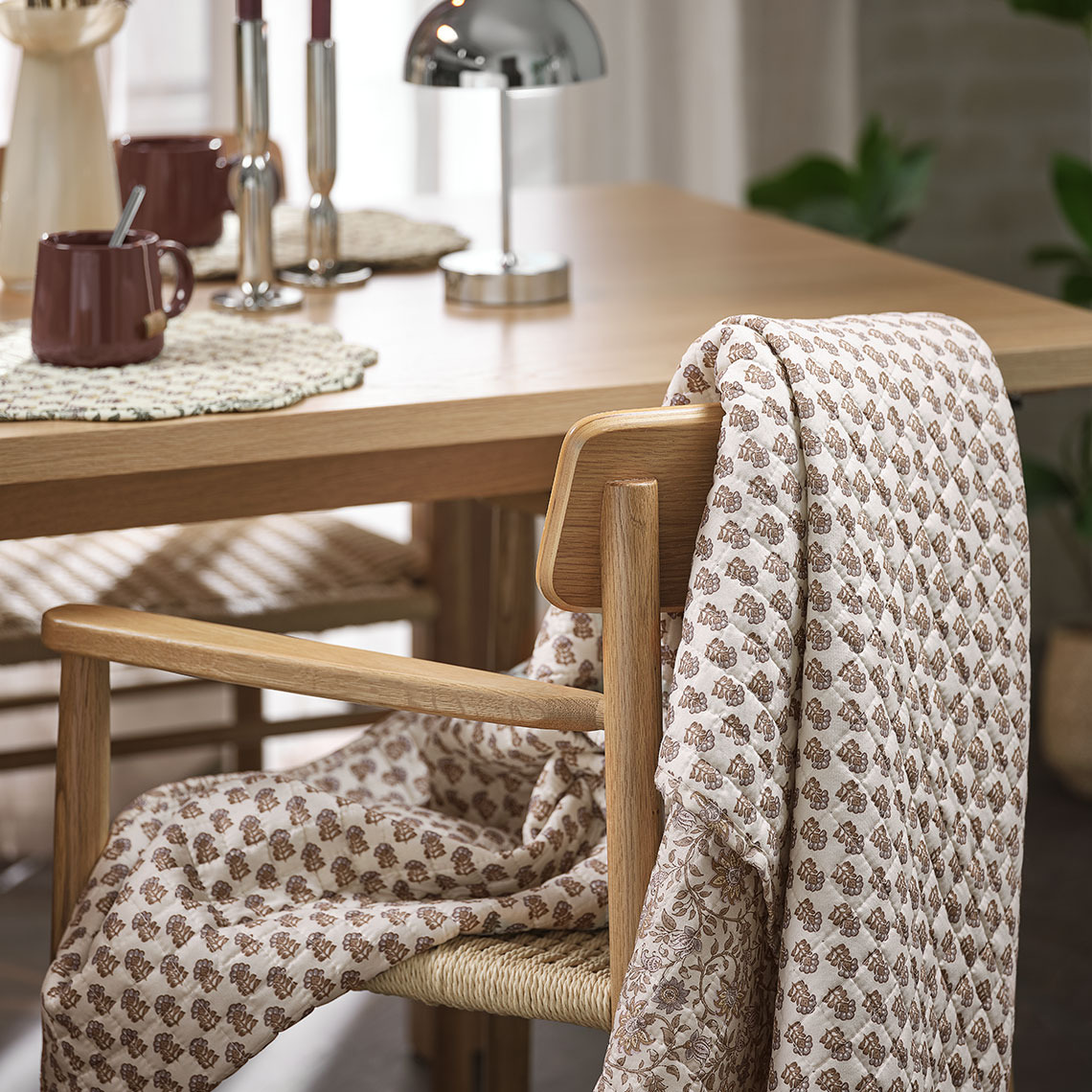 Quilted blanket hanging over a dining chair