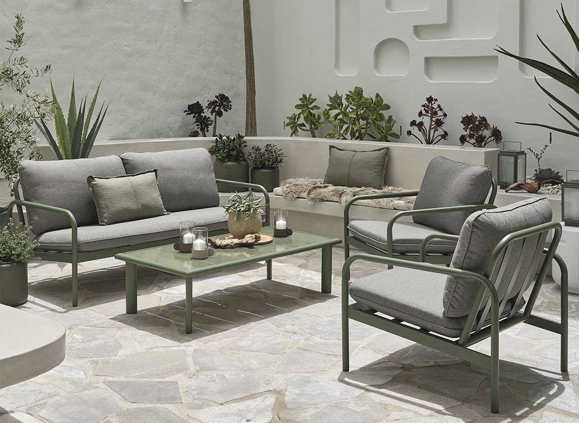 Olive green garden lounge set on a patio with cushions