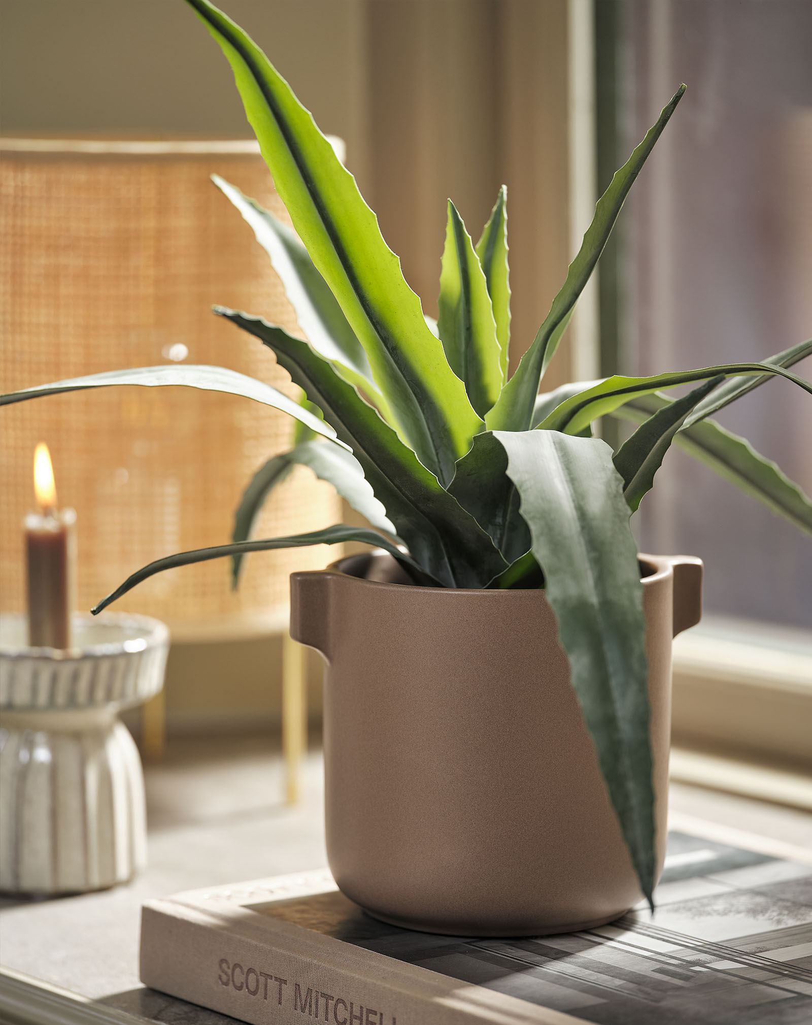 Artificial plant imitation of a deep green aloe vera plant in a plant pot