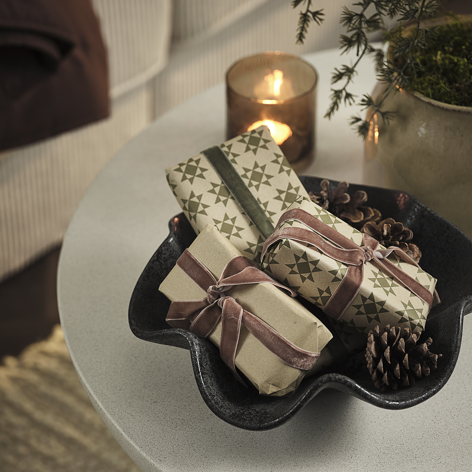 Bowl with Christmas presents and pinecones 