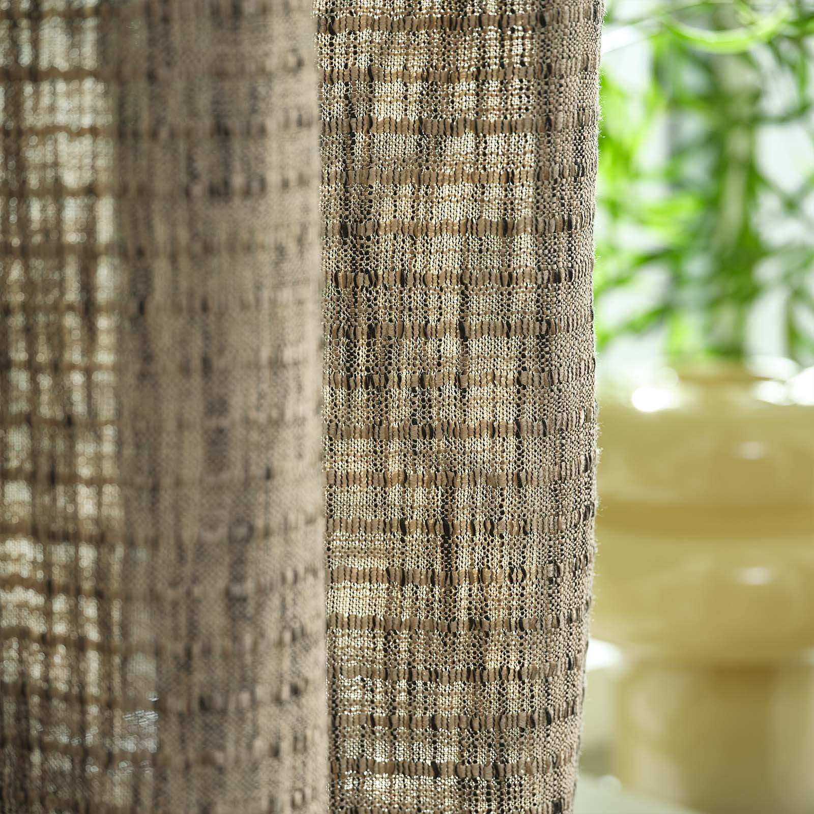 HAREIDLANDET curtain in sandy green Close-up of a sandy, green-coloured heavy curtain in front of window