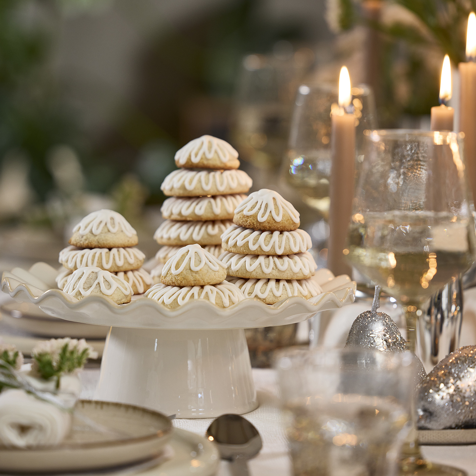 Dinner table with marzipan ring cakes shaped into Christmas trees