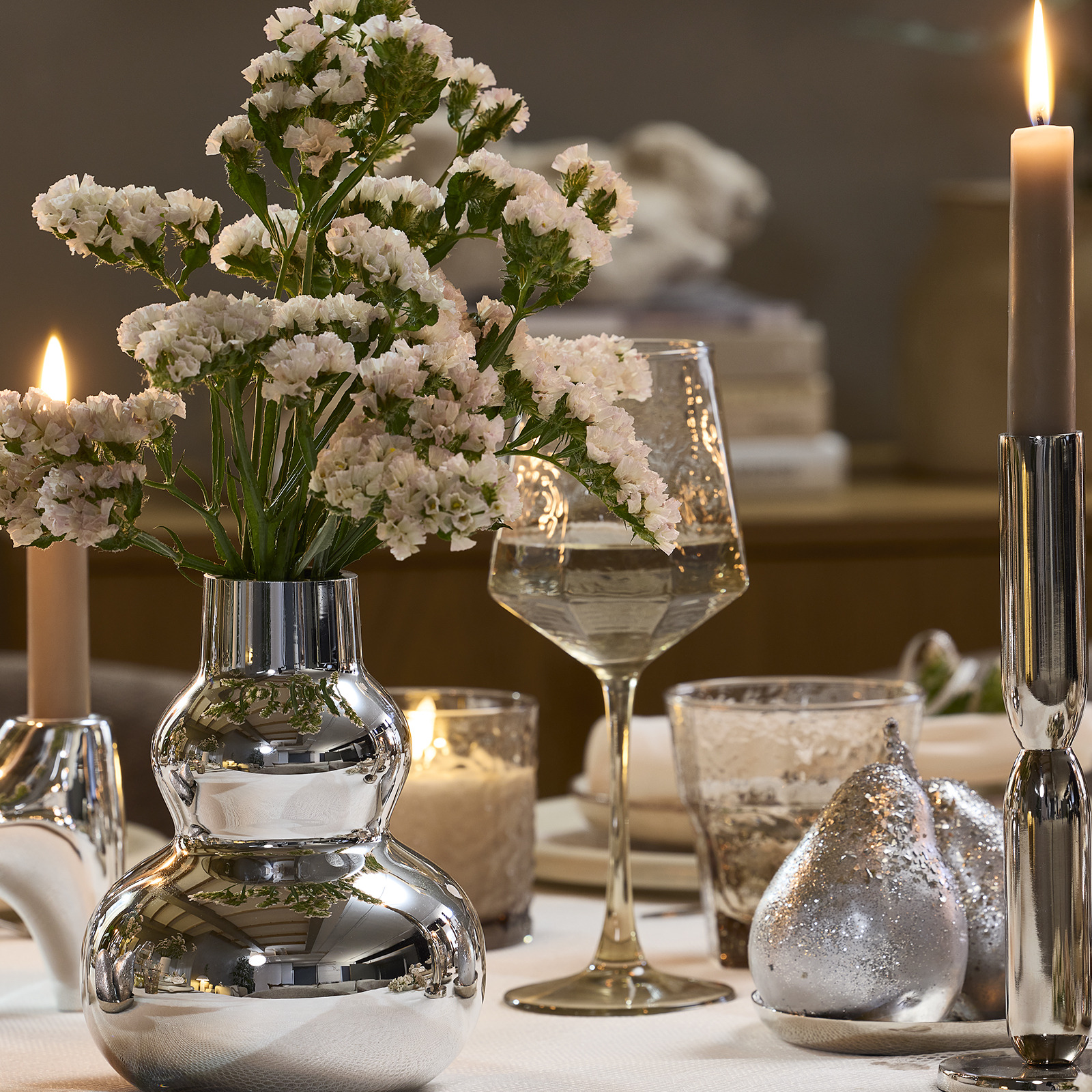 Dinner table with wine glass and vase in silver look
