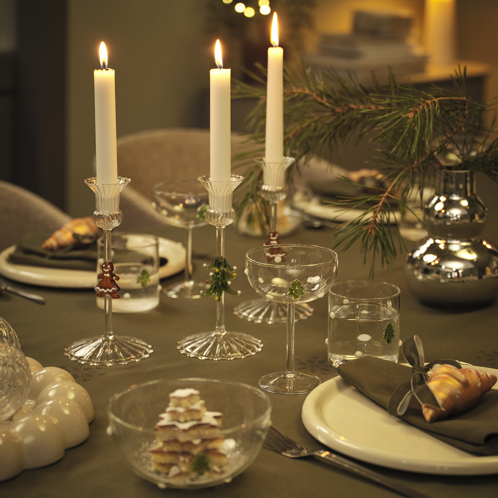 SILL candle holders and GABBRO bowls, drinking glasses and cocktail glasses Dining table lit up by candles in Christmas candle holders