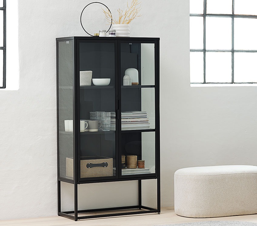 Black display cabinet with glasses, cups, books and storage baskets 