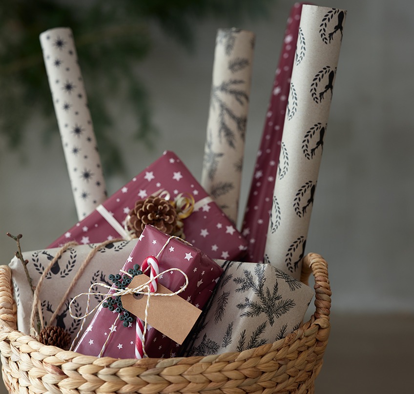 Wrapping paper and Christmas presents in a basket 