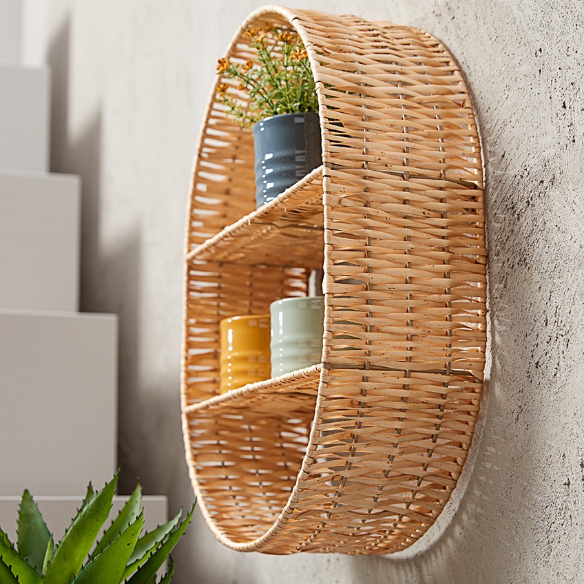 Wicker wall shelf with coloured plant pots 