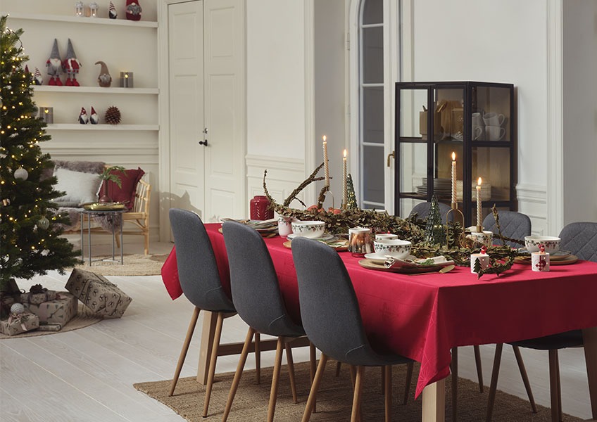 GULDSTEN tablecloth and decorations from our 2021 Christmas collection Dining table decorated for Christmas and Christmas tree with presents