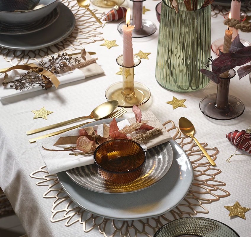 Grey and blue plates and gold cutlery on New Year’s table