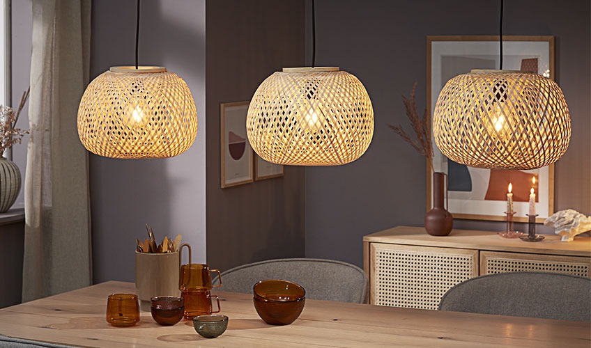 Three bamboo pendants hanging over dining table 
