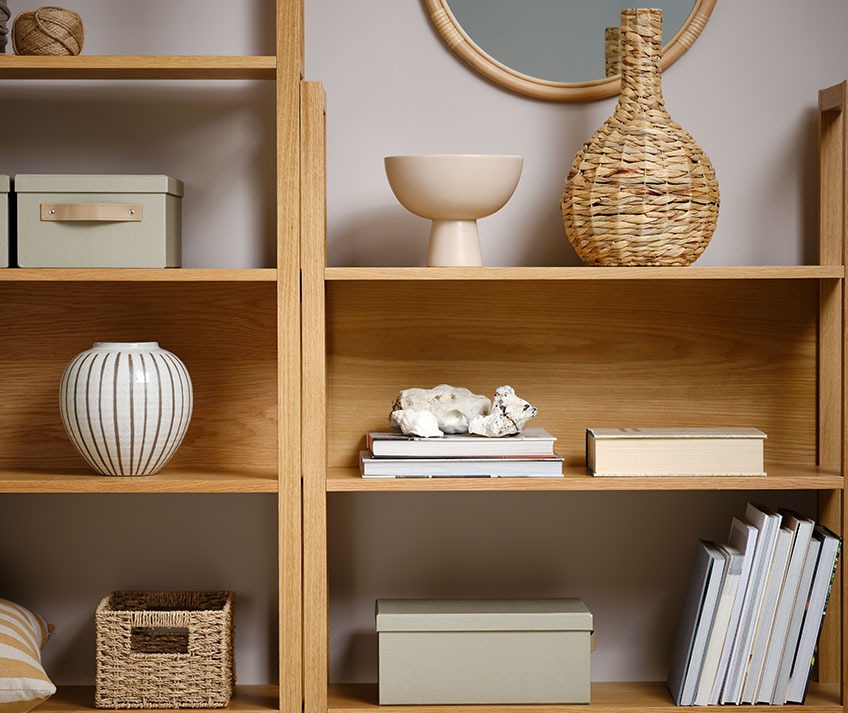 Bookcase with wicker vase, bowl, storage boxes and other decorative items  