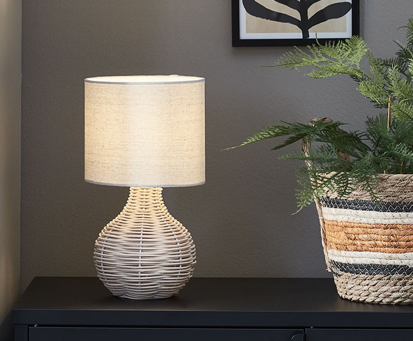 Table lamp in rattan and with a beige lampshade