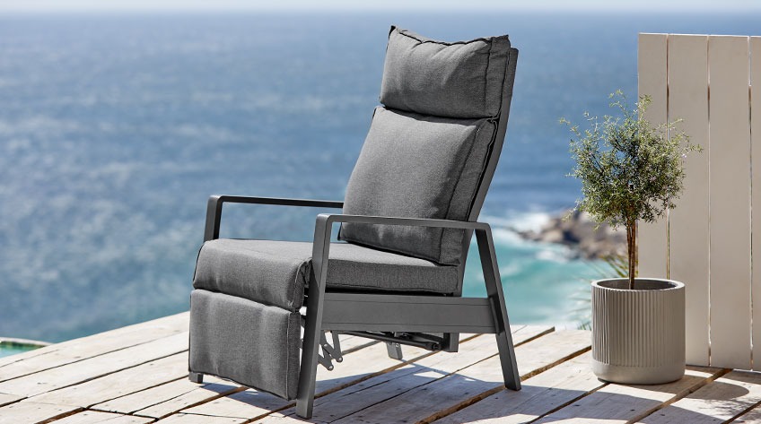 Recliner garden chair on a patio by the ocean