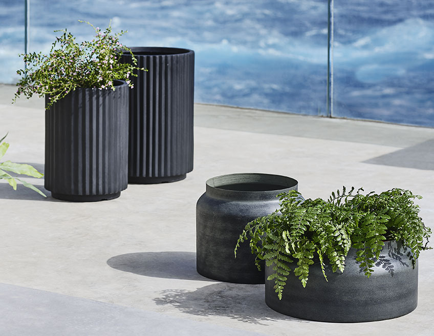 Tall garden planters and low garden planters on a large balcony