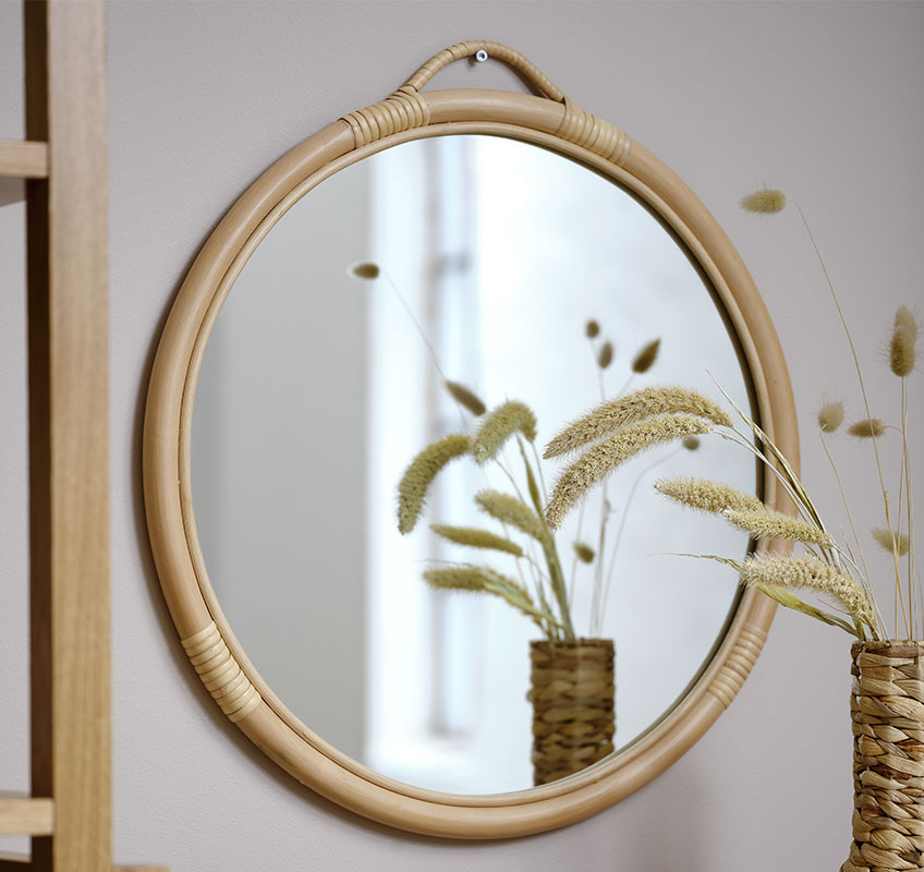 REFLECT rattan mirror Round rattan mirror on beige wall