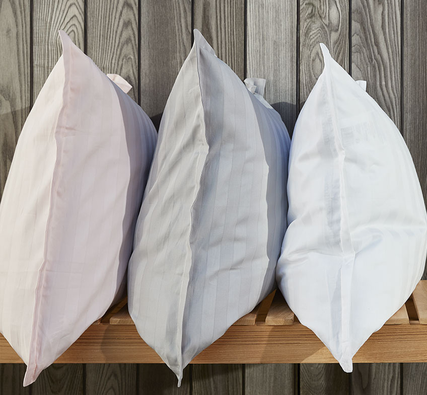 NELL duvet cover set is available in white, light grey, anthracite grey, and light blue Three pillows with pillowcases in rose, grey and white