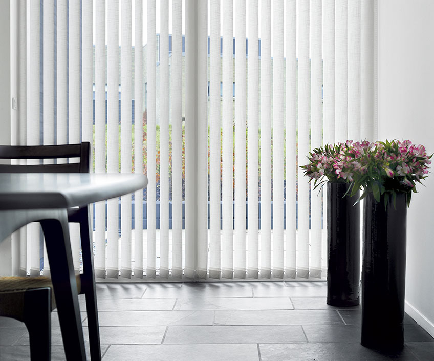 White vertical blinds in a dining room