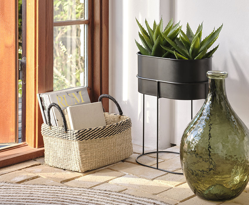 Basket, green floor vase and black pedestal