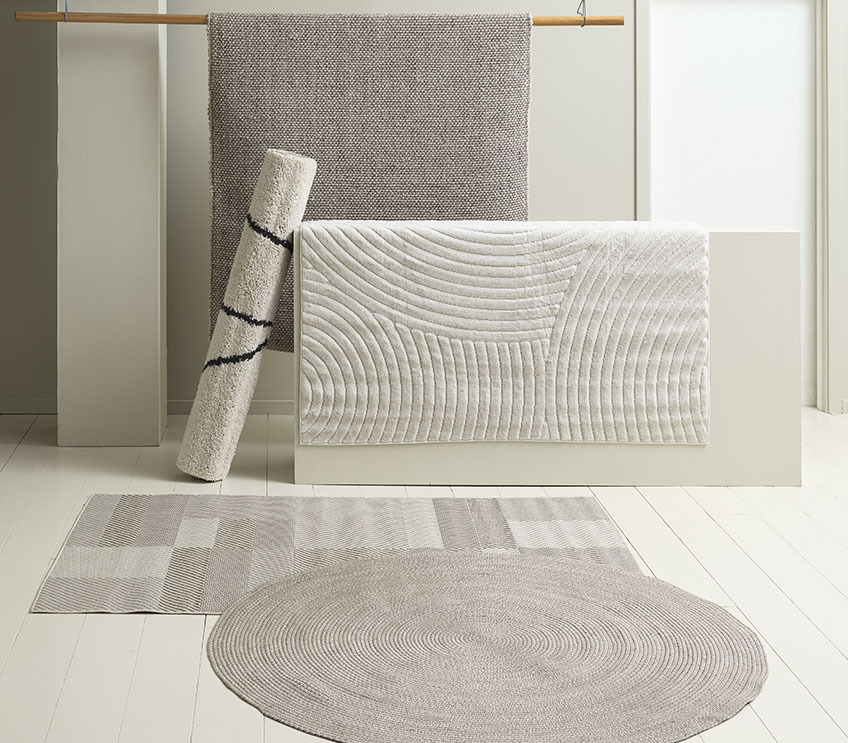 Round MASKROS rug on top of LONAS square rug. Cream coloured SANDFIOL rug hanging in front of AVENBOK grey/brown rug Round indoor-outdoor rug in front of square rugs in different natural colours