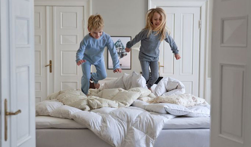 Children playing on a bed Children playing on a bed