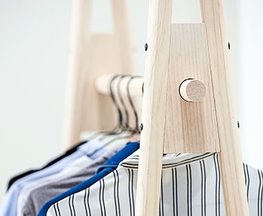 Black wire hangers on clothes hanging rail